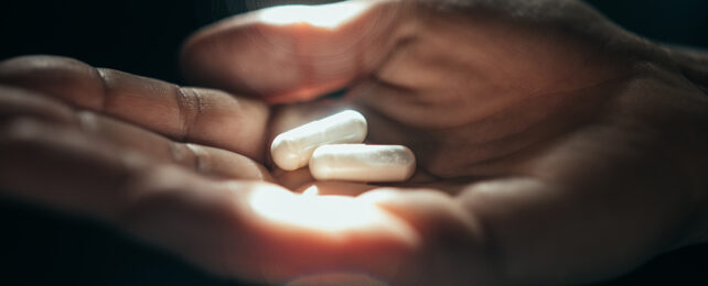 white pills in an open hand