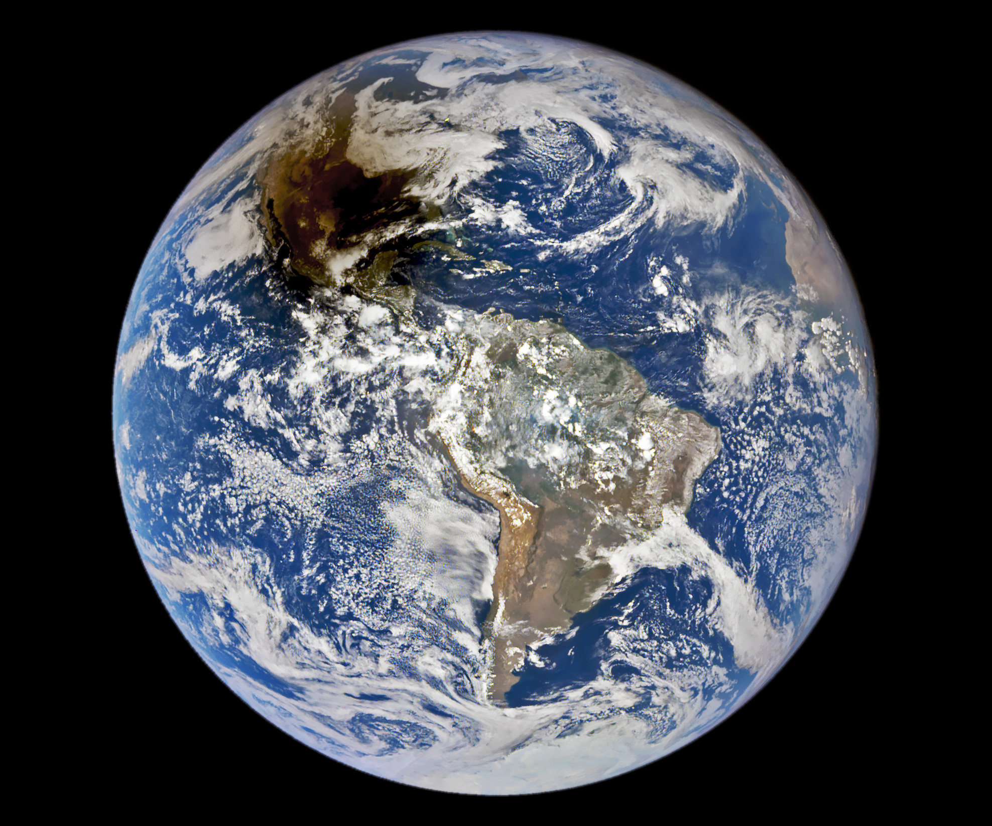image of the entire earth in black space. a dark black/brown shadow can be seen across the united states.