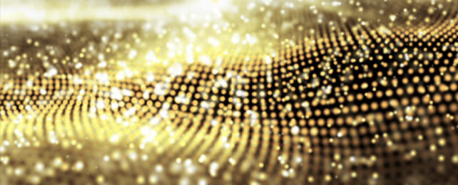 Abstract image of a golden material with particles shimmering in light.
