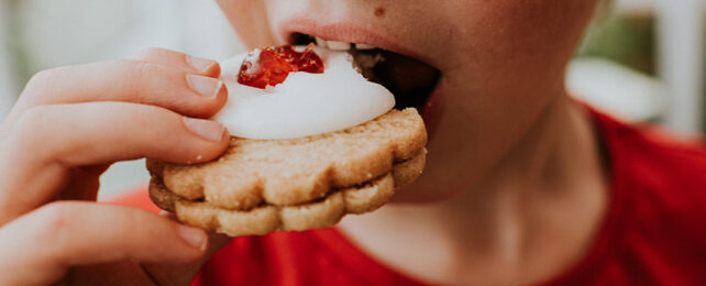 Boy eating a biscuit