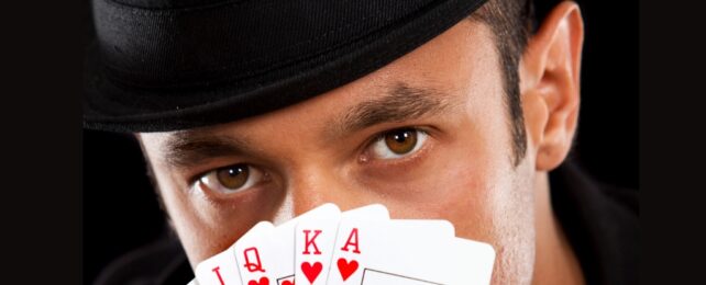 Brown eyes close up behind cards