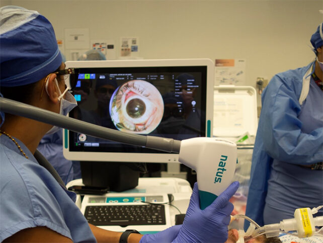 Doctor examining scan of eye on computer screen