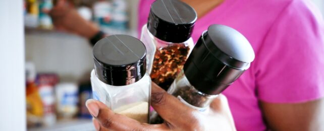 Woman Holds Pantry Spices