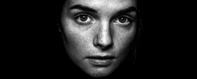 Womans Face In Dark Room