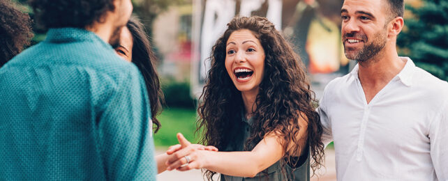 person pointing in a group of friends