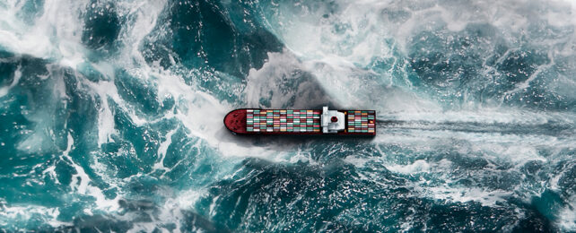 stormy ocean waves surrounding a cargo ship