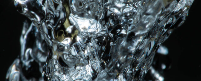 close-up image of water pouring from faucet