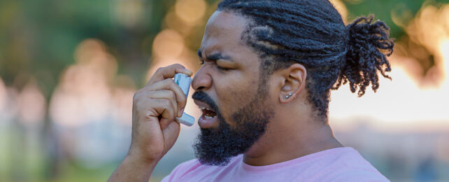 Man about to inhale steroid asthma puffer
