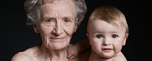 old woman and baby on a black background