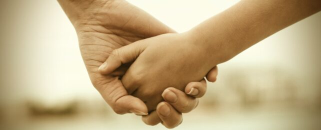 Child And Parent Hold Hands
