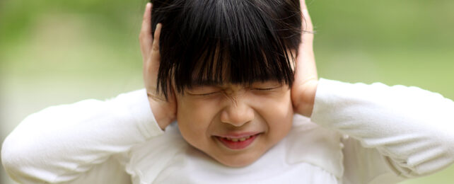 Kid hearing a loud noise