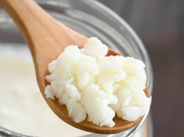 Kefir on a wooden spoon