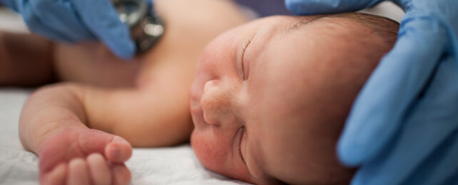 newborn baby with stethoscope on chest