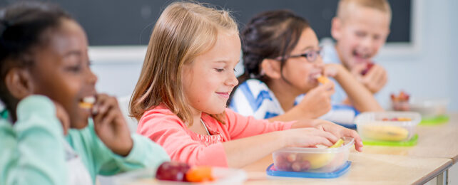 young children eating lunch in the classroom