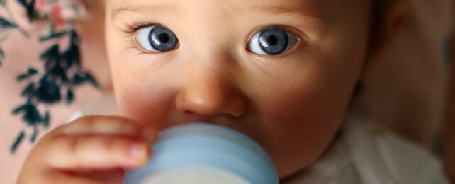 Baby Girl Drinks From Bottle