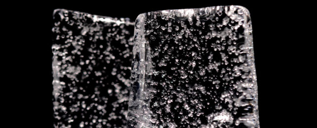 Close up picture of block of ice containing air bubbles.