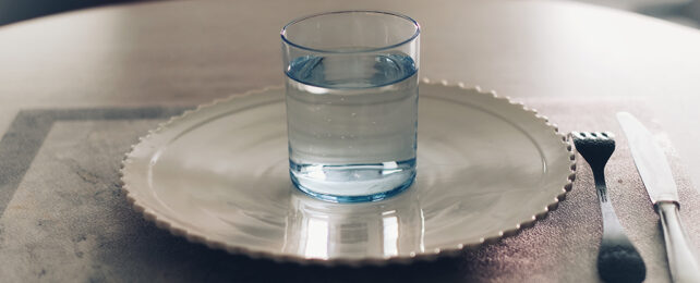 Glass of water and an empty plate