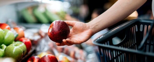 Shopper Picks Up Apple In Supermarket