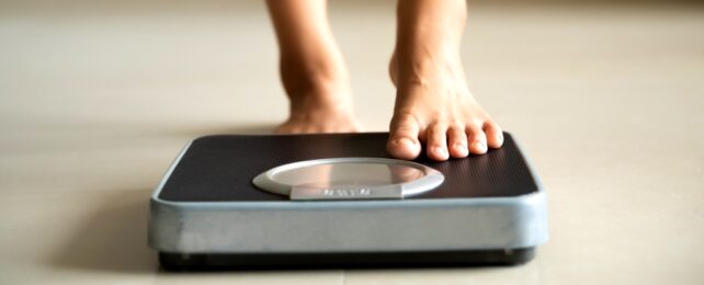 Woman Steps On Scales