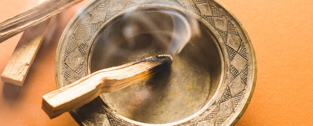 Palo Santo wood burning in a bowl