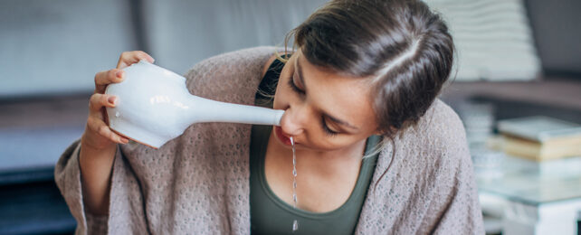 woman using neti pot