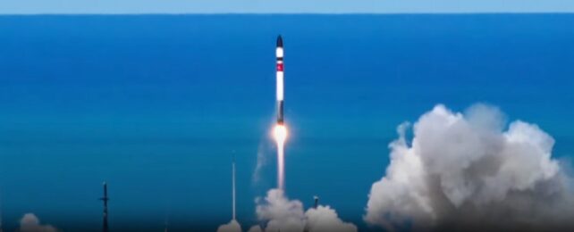 A rocket launching against a bright blue sky