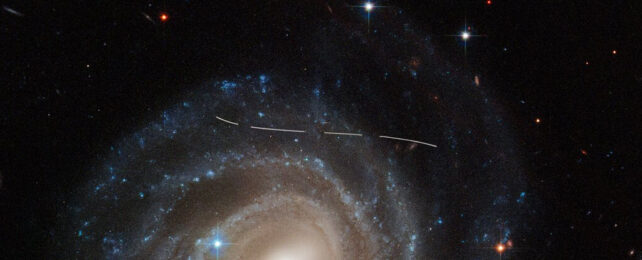 line across snapshot of Galaxy UGC 12158 indicating an asteroid