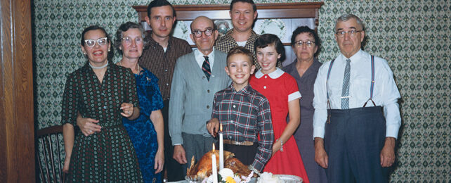 three generations standing around at thanksgiving in the 1950s