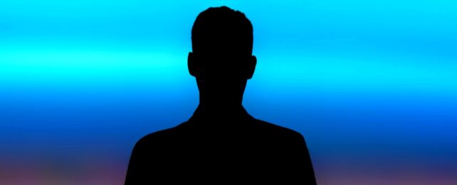 Man Silhoutted Against Colorful Backdrop