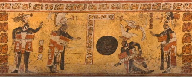 Four ballplayers covered in black body paint and wearing animal headdresses depicted on a Late Classic Maya vase