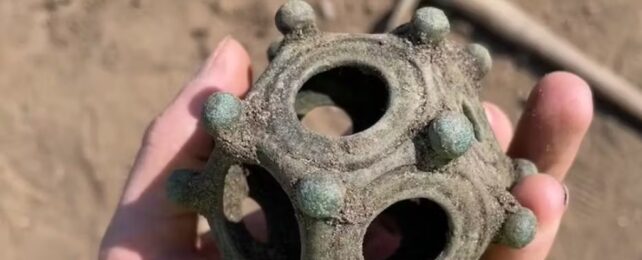 A hand holding the Roman dodecahedron