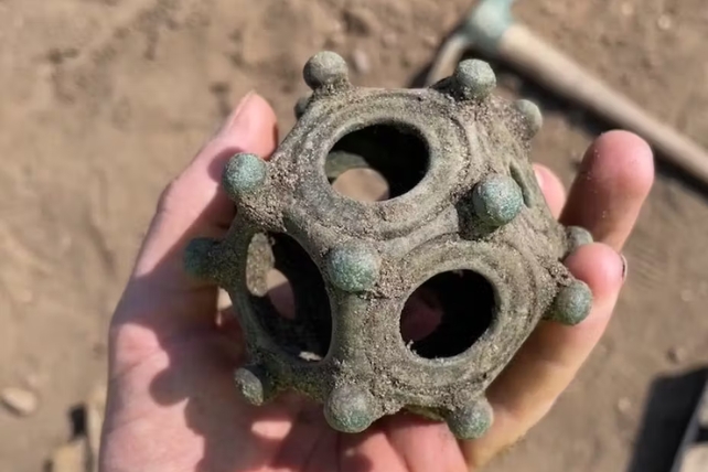 A hand holding the Roman dodecahedron