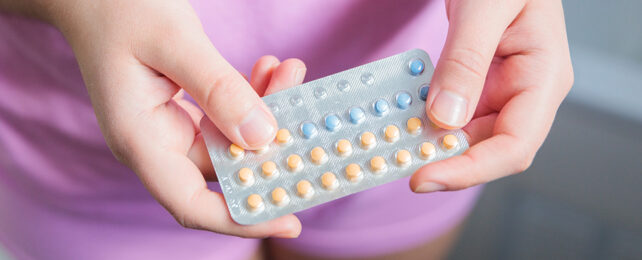 hands holding a pack of contraceptive pills
