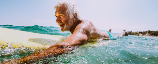 elderly man surfing