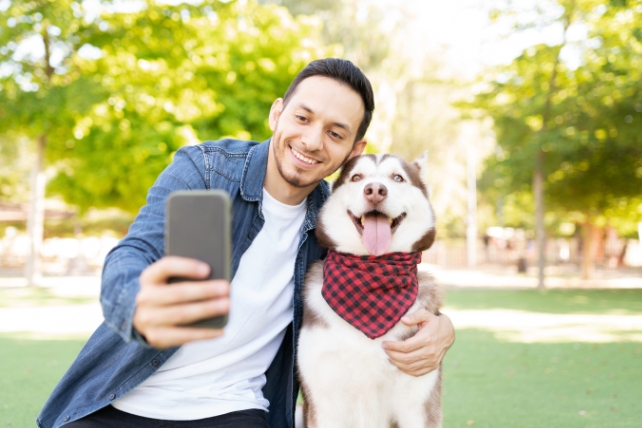 Dog and human taking selfie outdoors