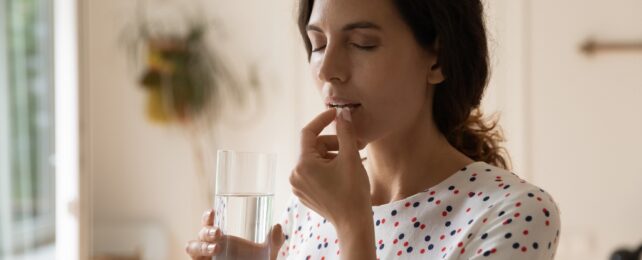 woman taking pill
