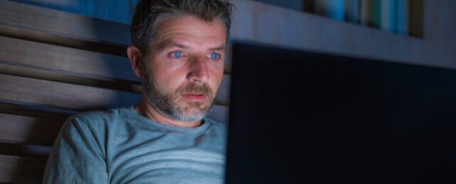 man watching computer screen