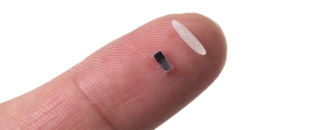 finger showing tiny size of pacemaker