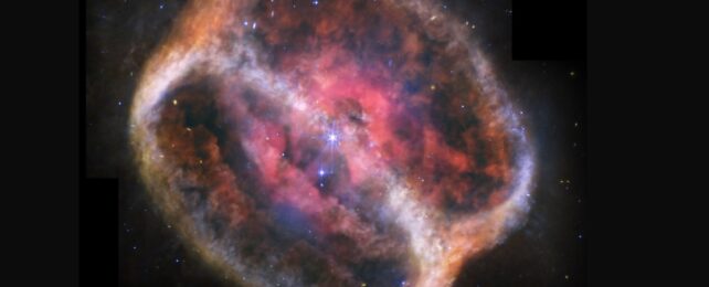 What looks like a single large, bright star (but is two) shines with bright purple diffraction spikes at the center of a large, diffuse cylinder of gas and dust that is tipped to the right