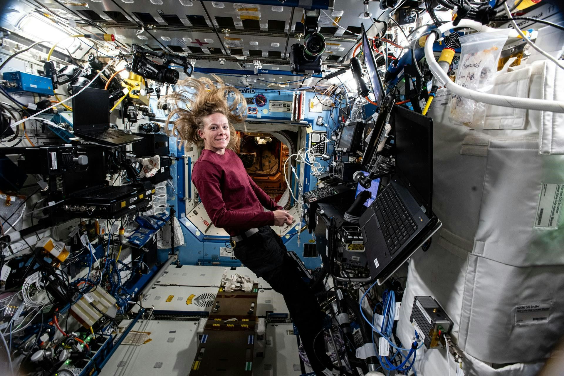 Female astronaut with hair flowing weightlessly on the international space station