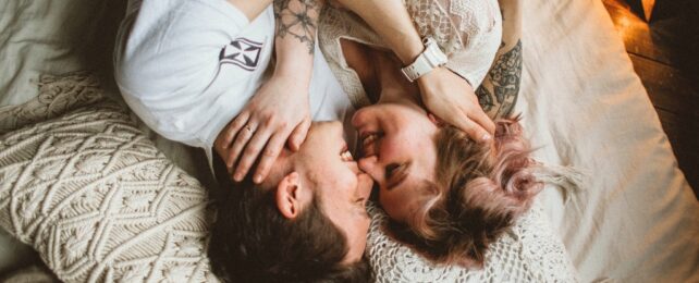 Two young people laughing and cuddling