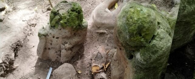 Two stone sculptures in the form of small humans