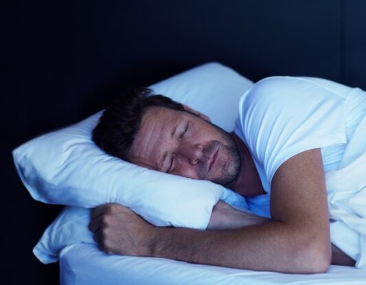 A man asleep in bed