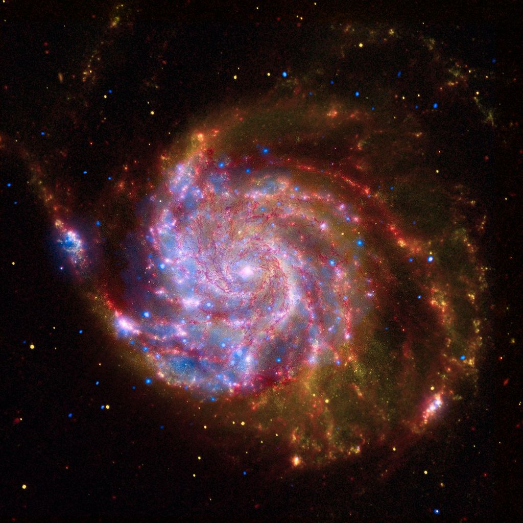 Colorful spiral galaxy with yellow and red highlighted with stars of blue