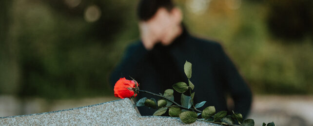 Sad man in a cemetery