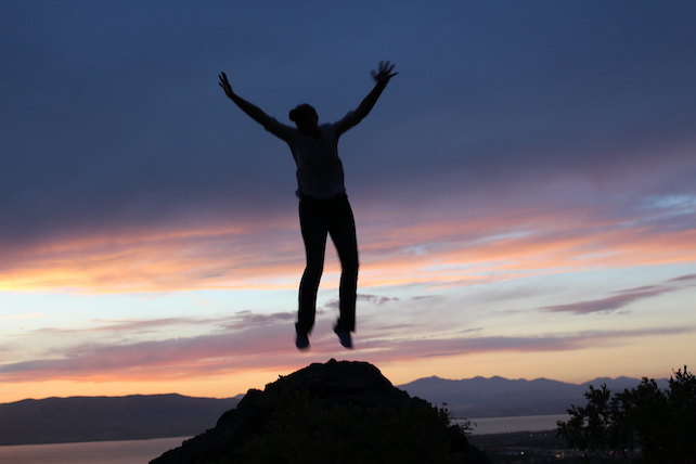 silhouette of person jumping for joy