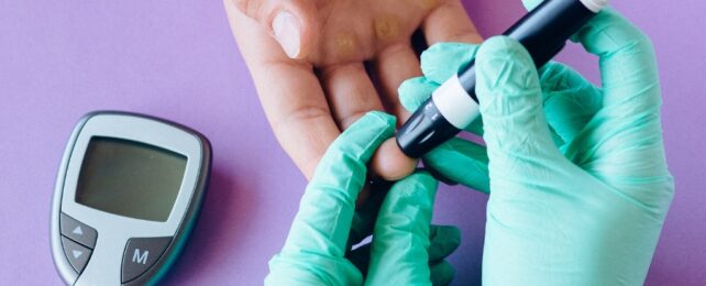 person's finger being pricked for diabetes test
