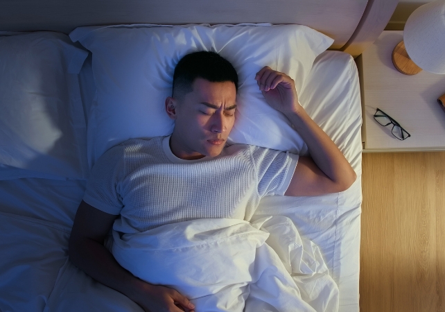 man sleeping in bed