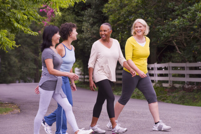 Older women walking together outdoors.