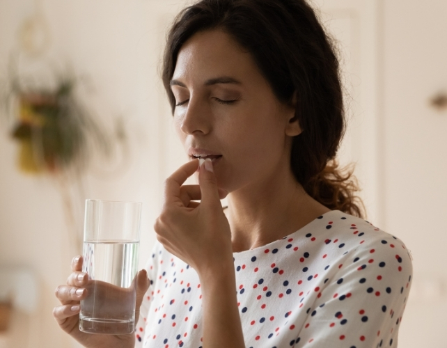 woman taking a pill